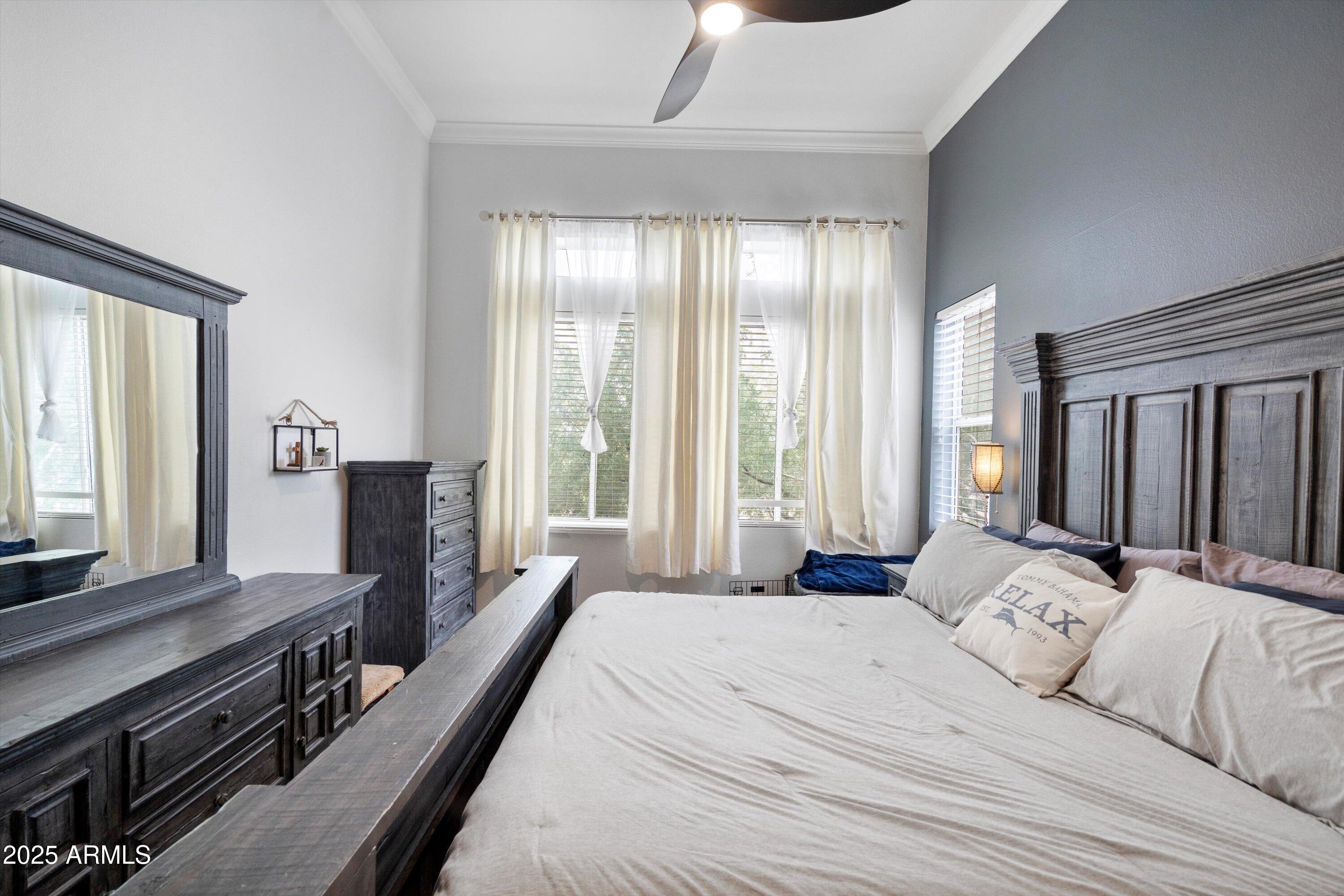 8245 East Bell Road, Unit 250 Scottsdale, AZ 85260 - Photo 26 of 48 a bedroom with a bed and wooden floor