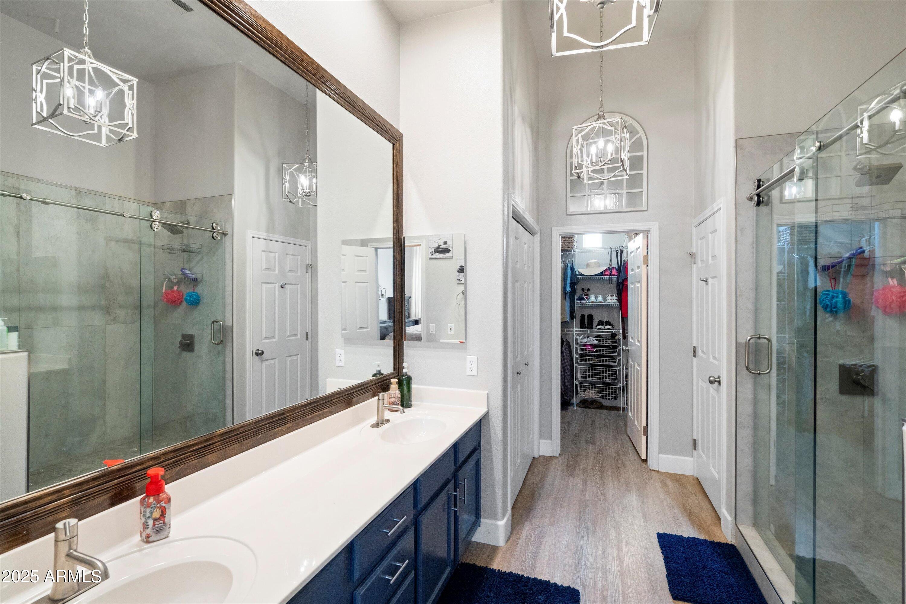 8245 East Bell Road, Unit 250 Scottsdale, AZ 85260 - Photo 27 of 48 a bathroom with a sink a mirror and a shower
