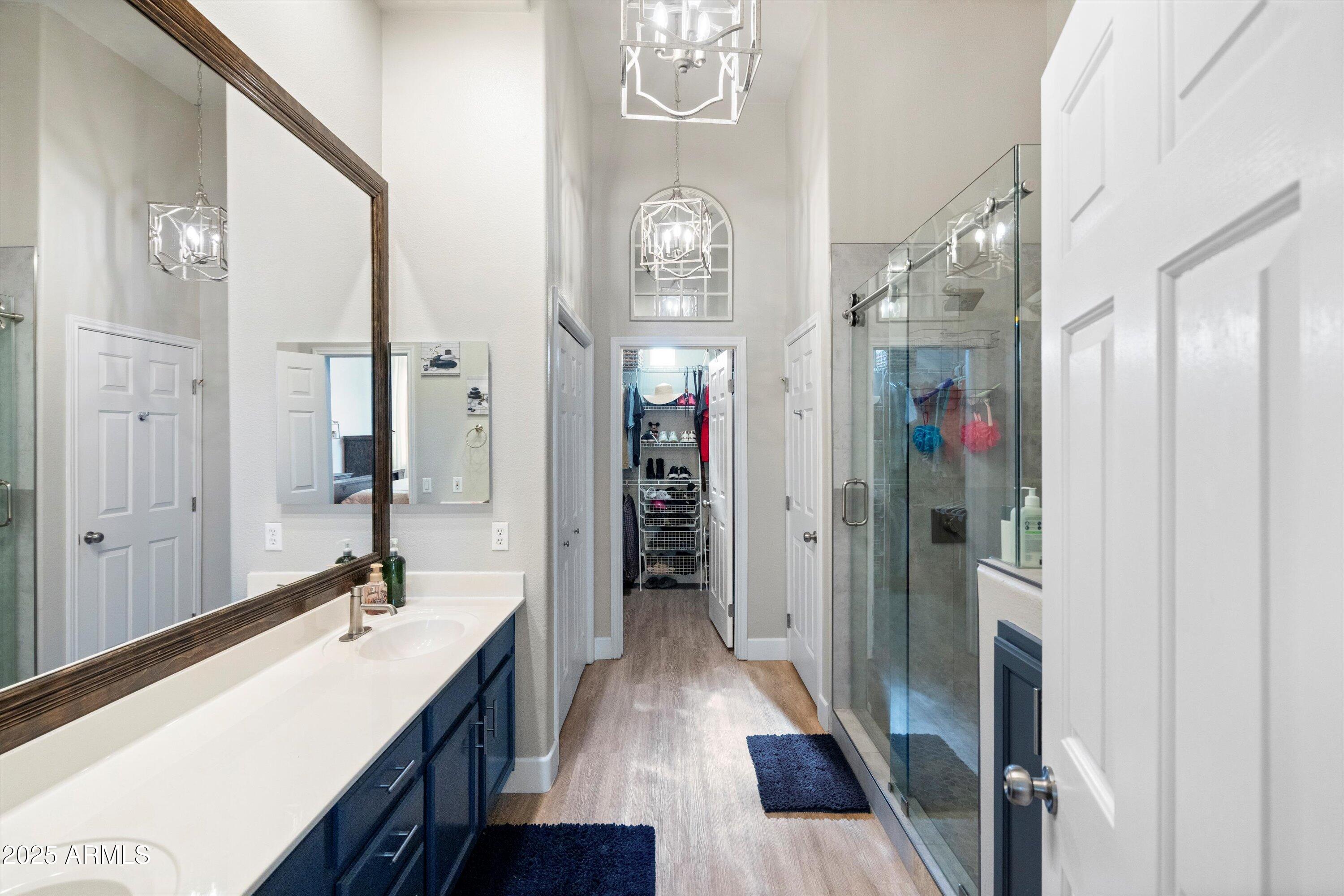 8245 East Bell Road, Unit 250 Scottsdale, AZ 85260 - Photo 28 of 48 a bathroom with a sink a mirror and a shower