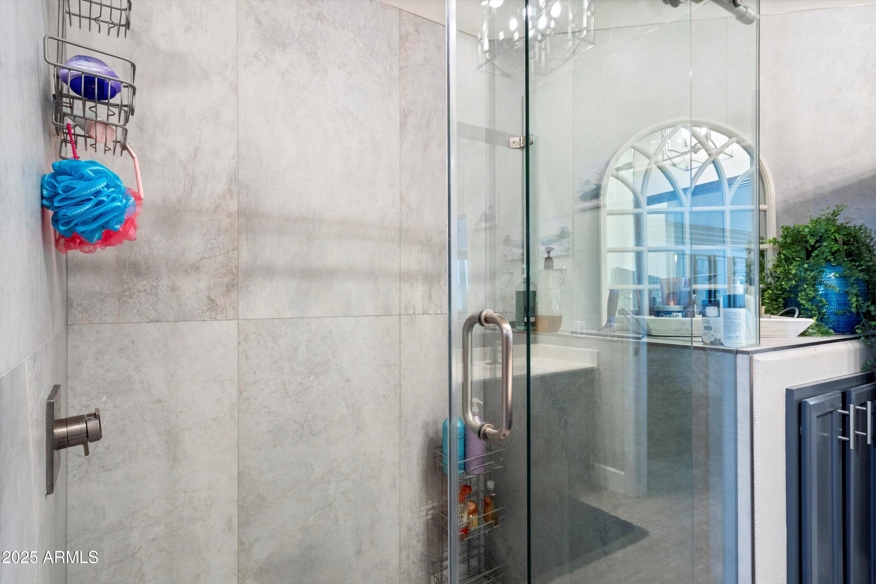 8245 East Bell Road, Unit 250 Scottsdale, AZ 85260 - Photo 29 of 48 a bathroom with a shower and a mirror