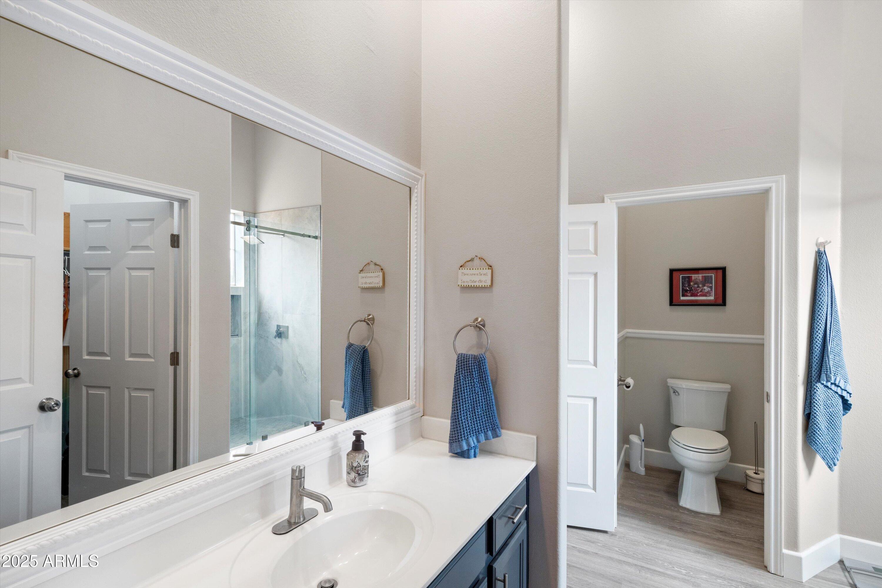 8245 East Bell Road, Unit 250 Scottsdale, AZ 85260 - Photo 33 of 48 a bathroom with a sink a toilet and shower