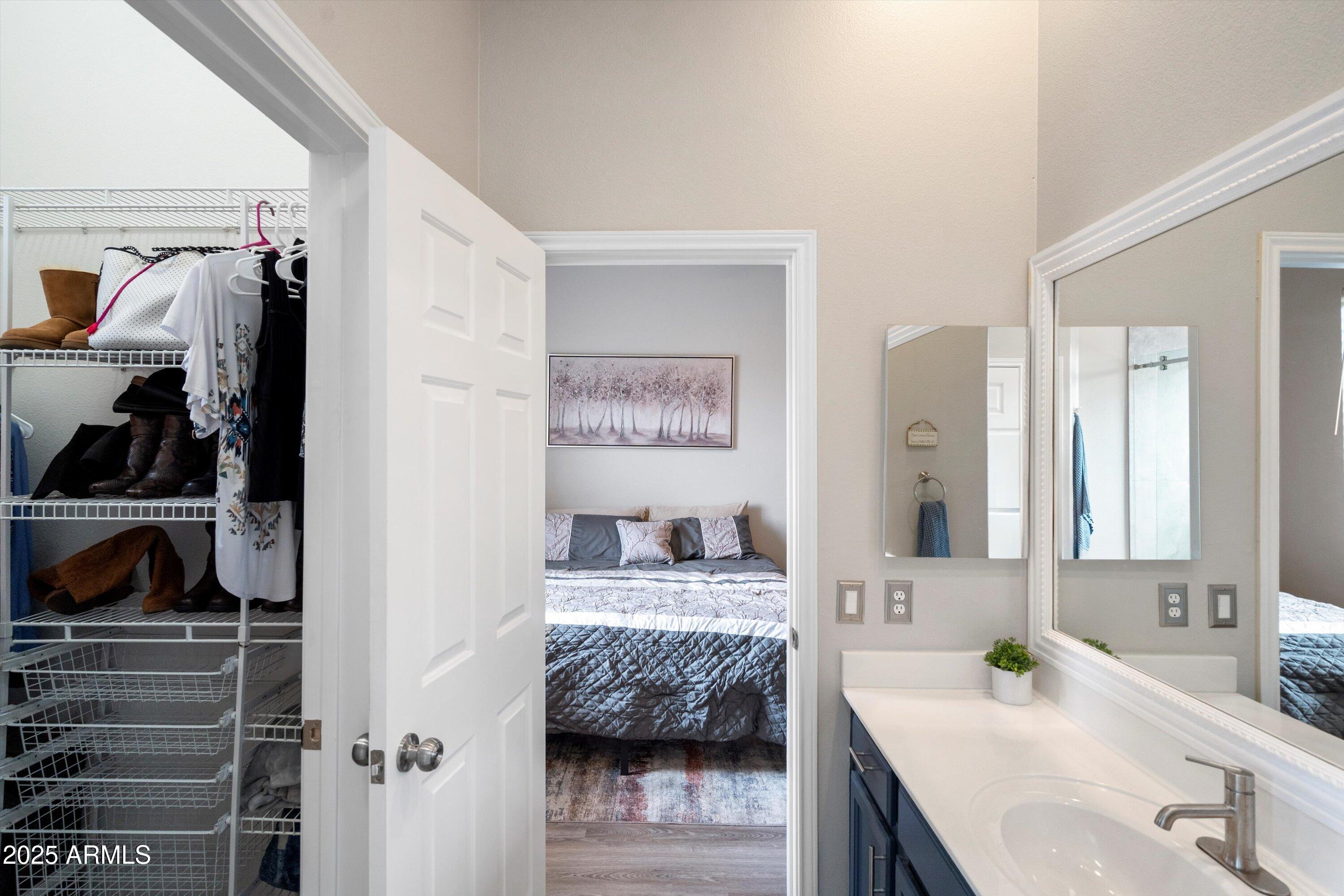 8245 East Bell Road, Unit 250 Scottsdale, AZ 85260 - Photo 34 of 48 a en suite bathroom with a double vanity sink and a mirror