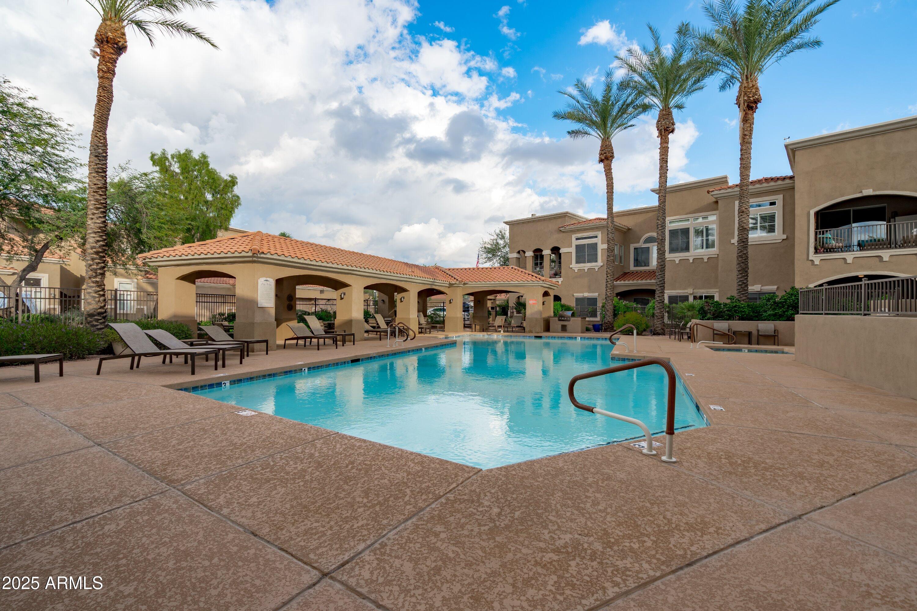 8245 East Bell Road, Unit 250 Scottsdale, AZ 85260 - Photo 38 of 48 a view of a swimming pool with a patio