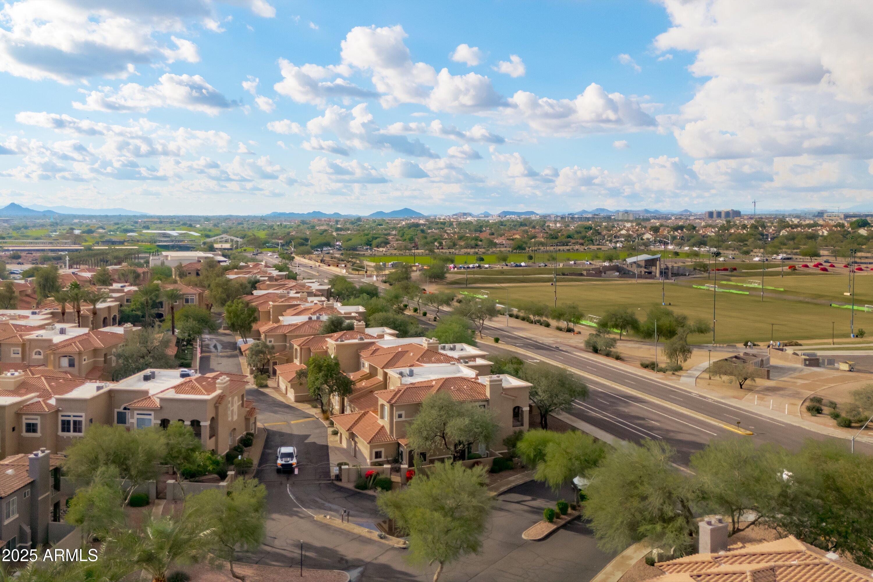 8245 East Bell Road, Unit 250 Scottsdale, AZ 85260 - Photo 42 of 48 an aerial view of a city with lots of residential buildings ocean and mountain view in back