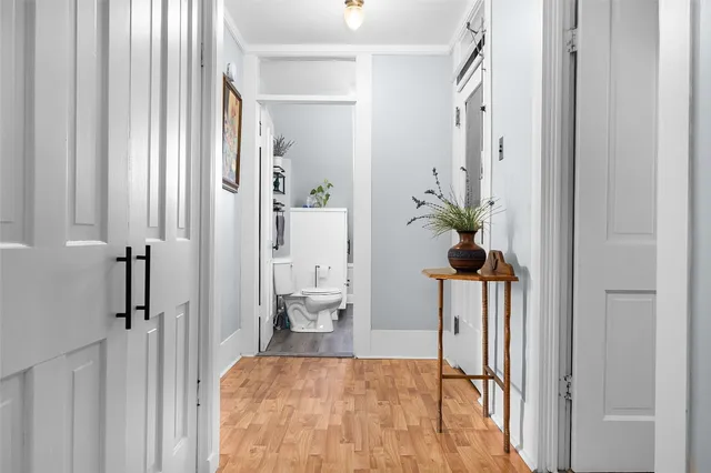 a view of a livingroom with wooden floor and furniture