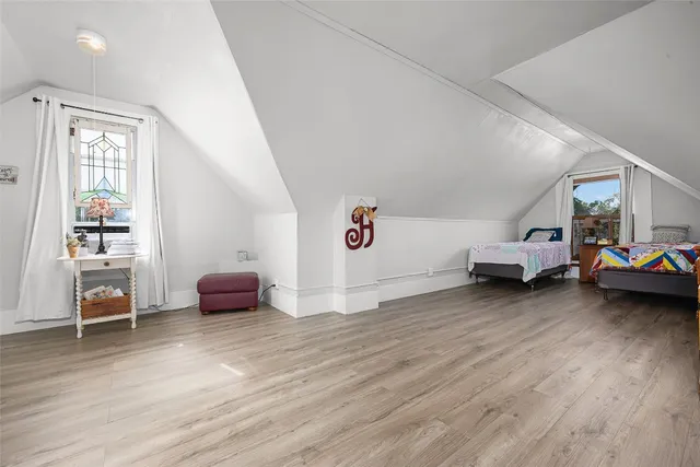 a bathroom with a double vanity sink mirror and bathtub