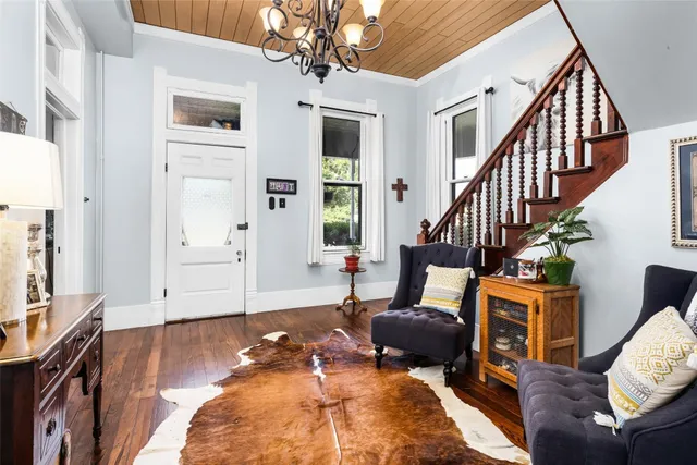 a living room with furniture or couch and a chandelier
