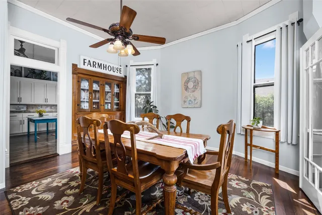 a dining room with furniture a chandelier and wooden floor