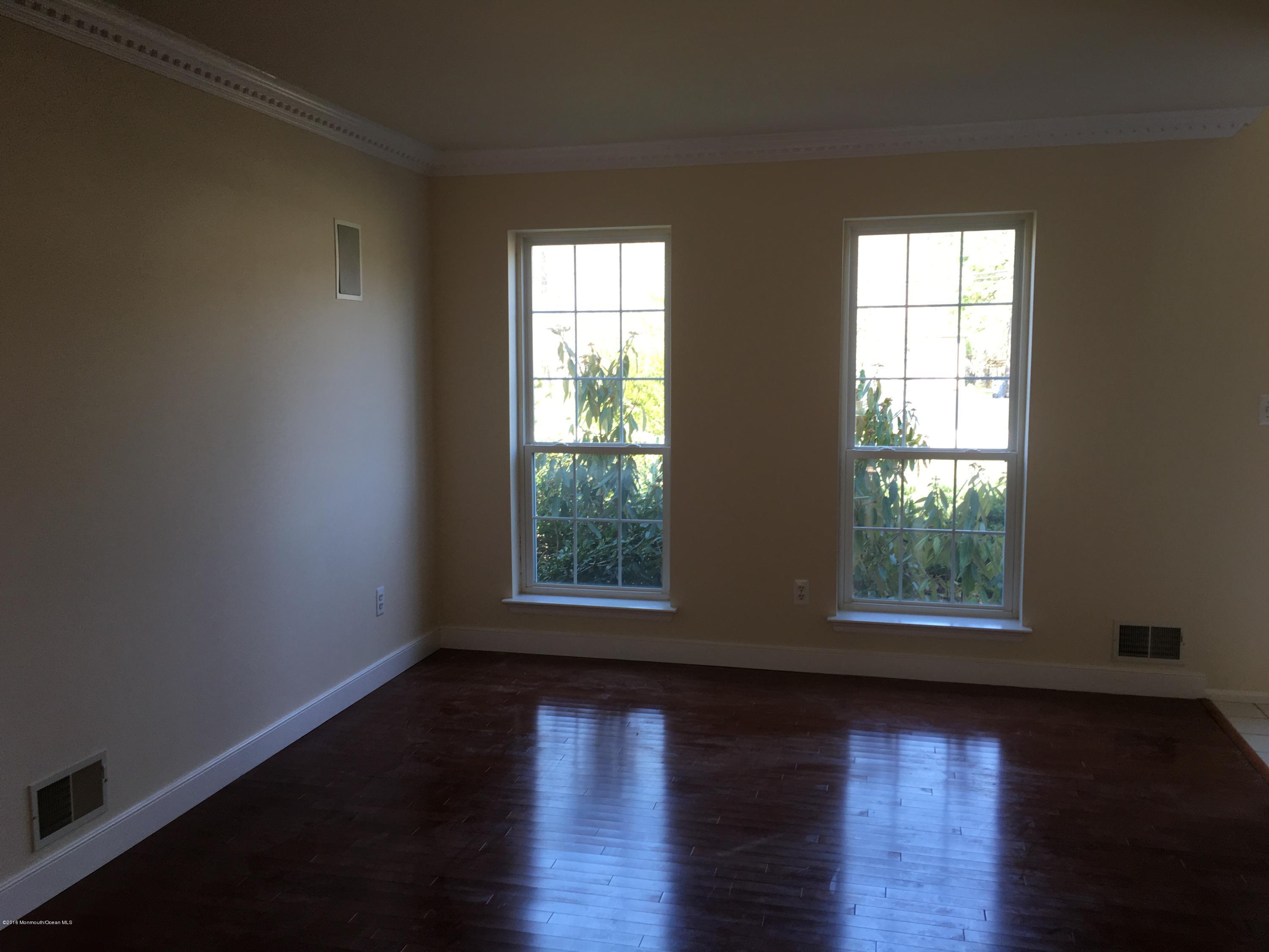 761 Anderson Road Jackson, NJ 08527 - Photo 4 of 22 an empty room with wooden floor and windows