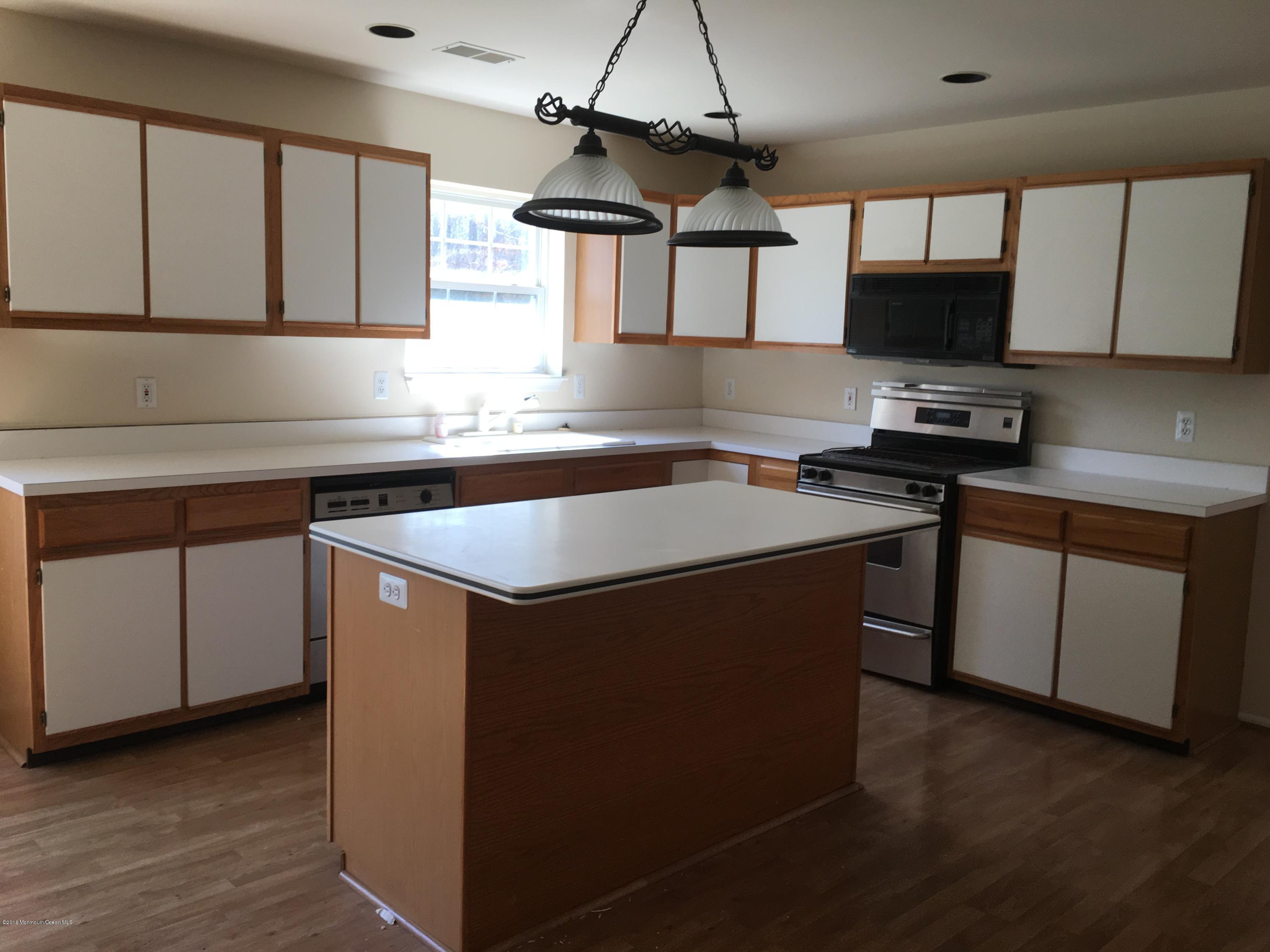761 Anderson Road Jackson, NJ 08527 - Photo 8 of 22 a kitchen with stainless steel appliances granite countertop a sink a stove and a microwave