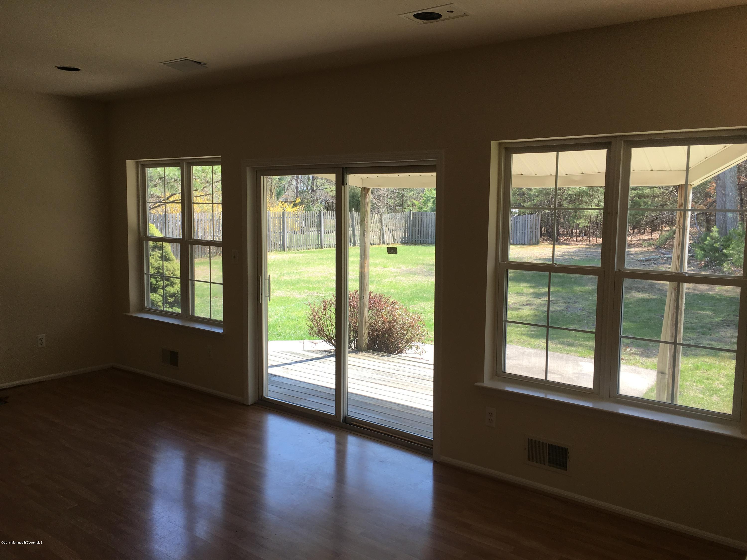 761 Anderson Road Jackson, NJ 08527 - Photo 9 of 22 a view of an empty room with wooden floor and a window