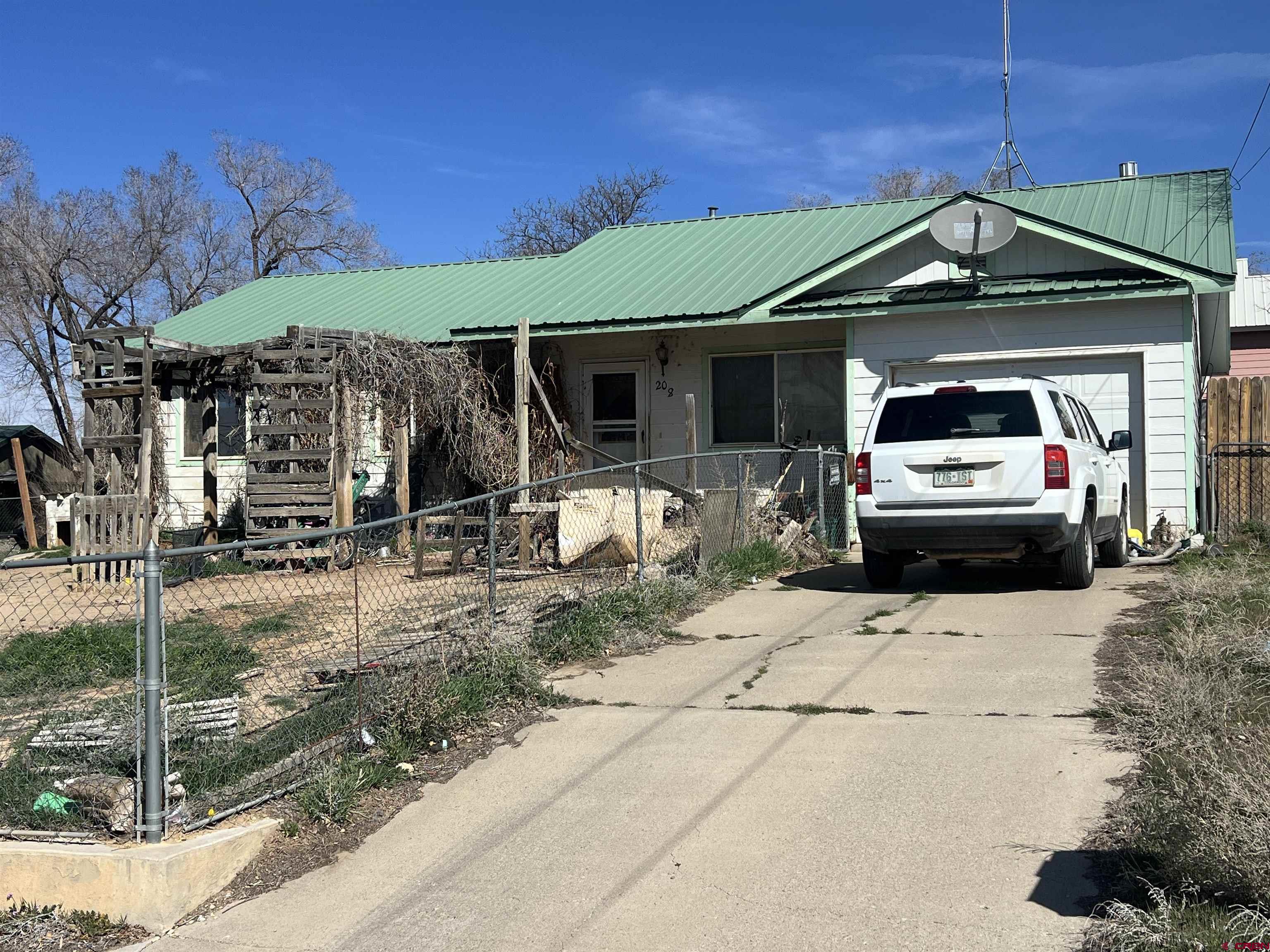 208 East 3rd Street Cortez, CO 81321 - Photo 1 of 4 a front view of a house with a yard
