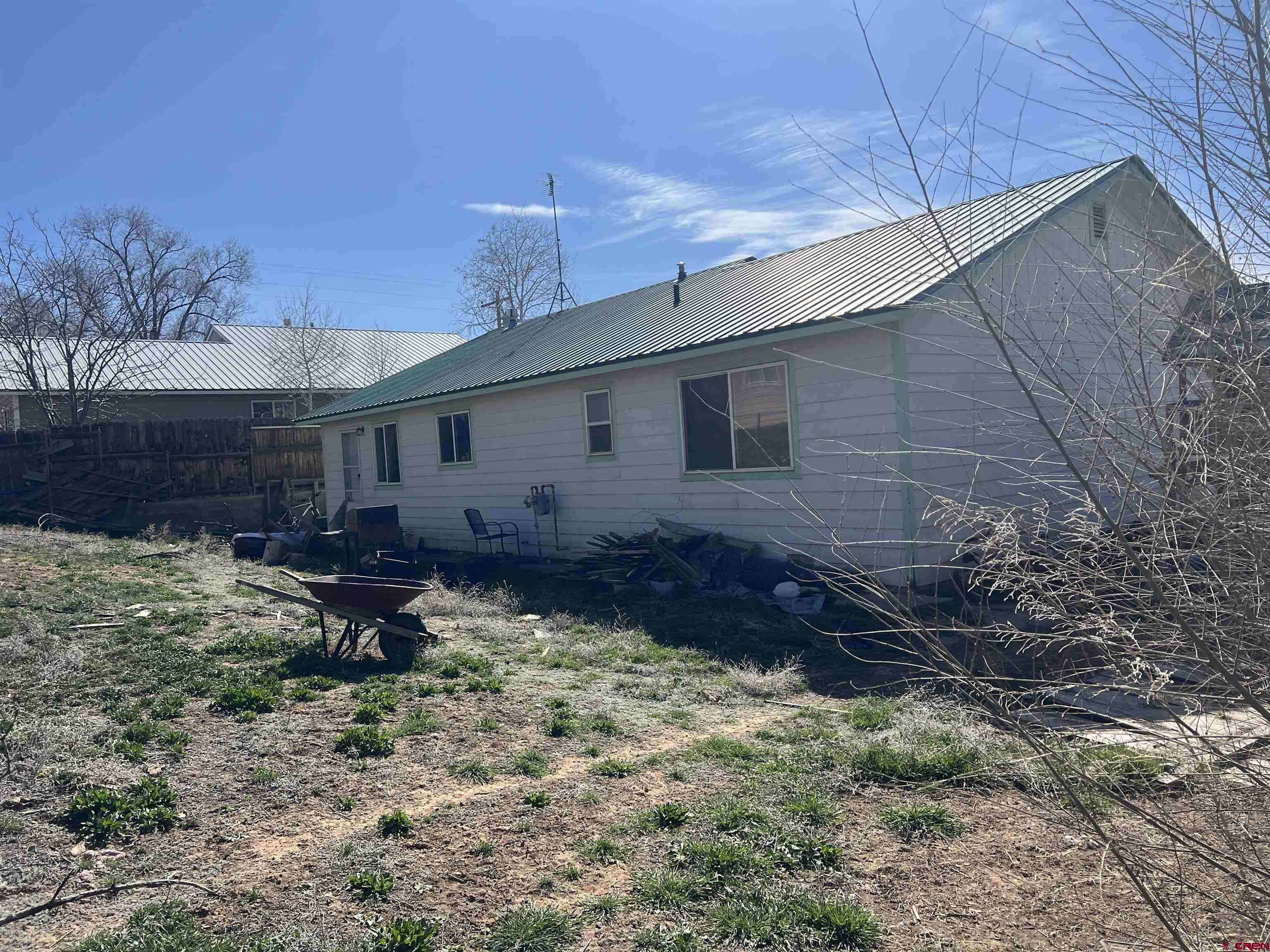 208 East 3rd Street Cortez, CO 81321 - Photo 2 of 4 a backyard of a house with lots of green space