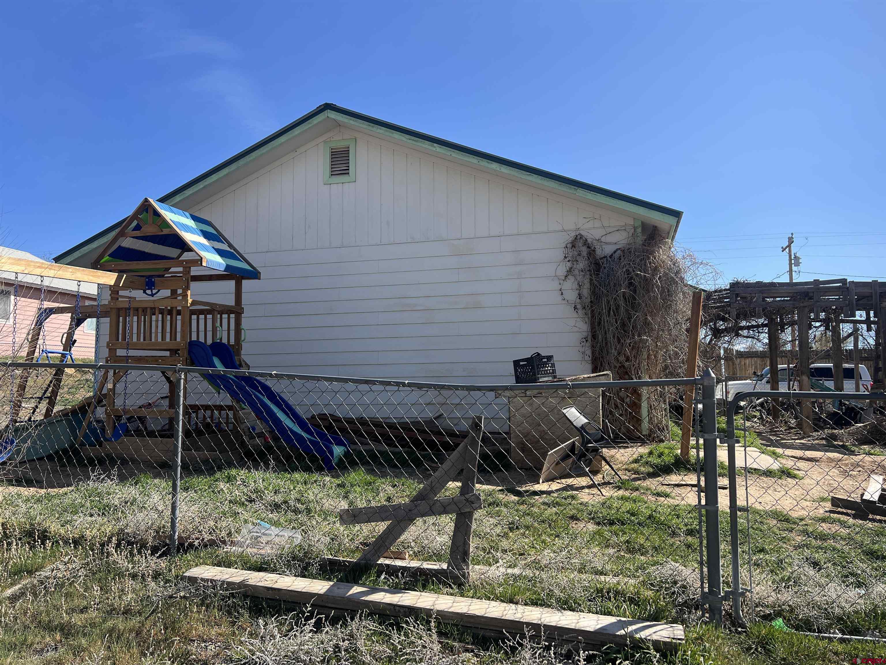 208 East 3rd Street Cortez, CO 81321 - Photo 3 of 4 a front view of a house with garden