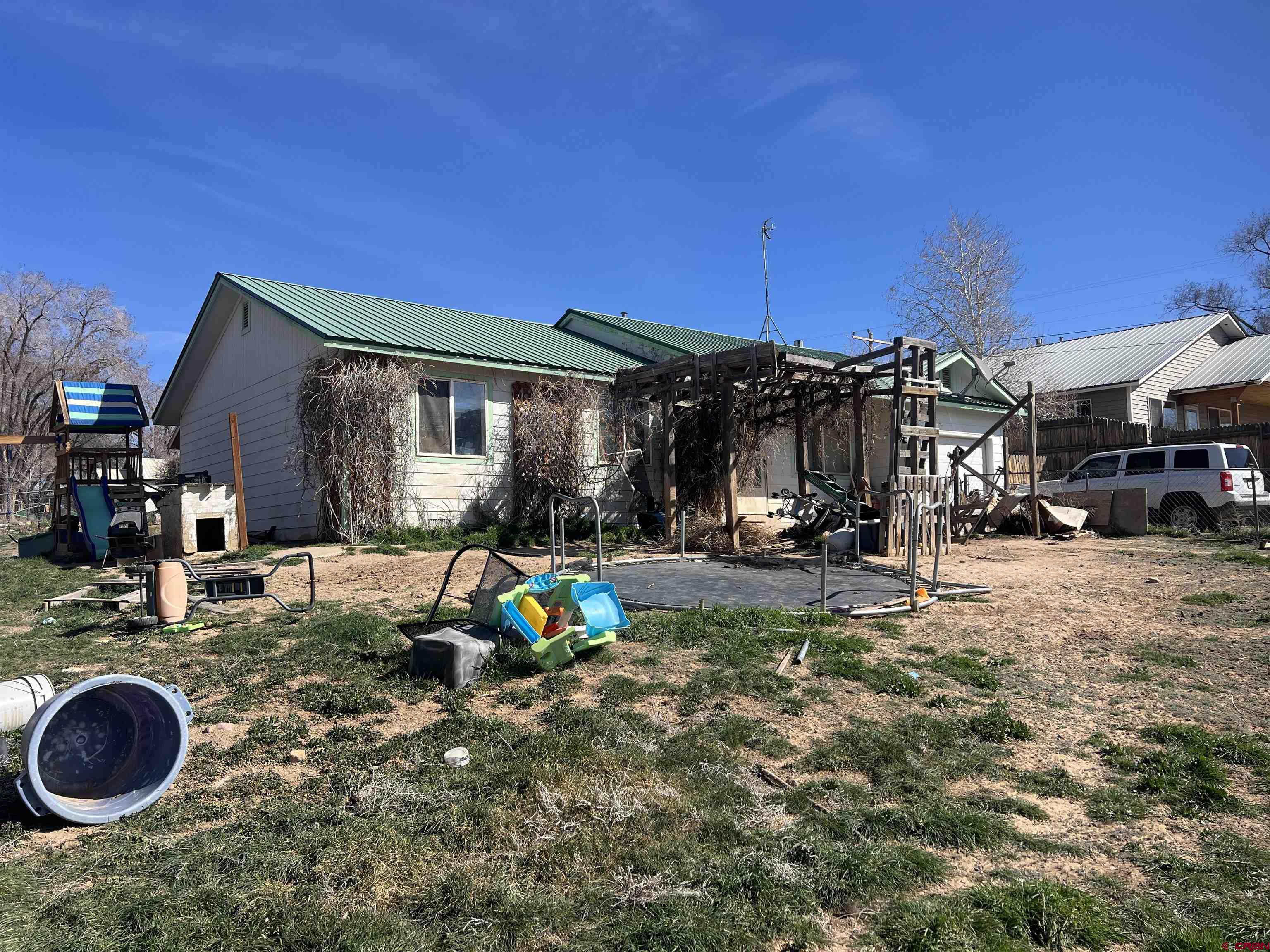 208 East 3rd Street Cortez, CO 81321 - Photo 4 of 4 a view of a house with backyard and porch