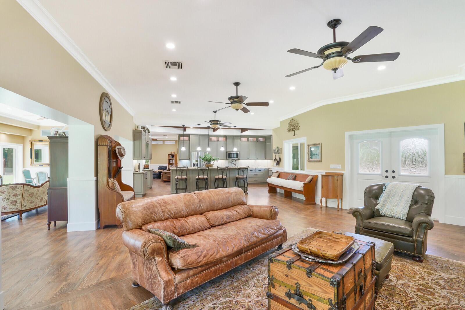 6624 Dillman Road Greenacres, FL 33413 - Photo 19 of 61 a living room with furniture kitchen view and a chandelier