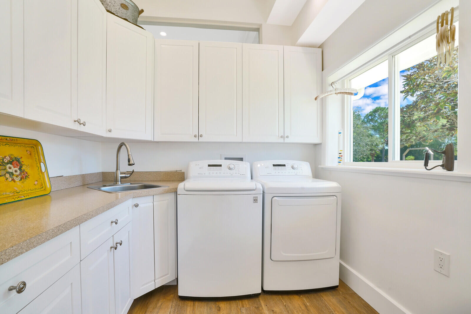 6624 Dillman Road Greenacres, FL 33413 - Photo 35 of 61 a utility room with cabinets washer and dryer