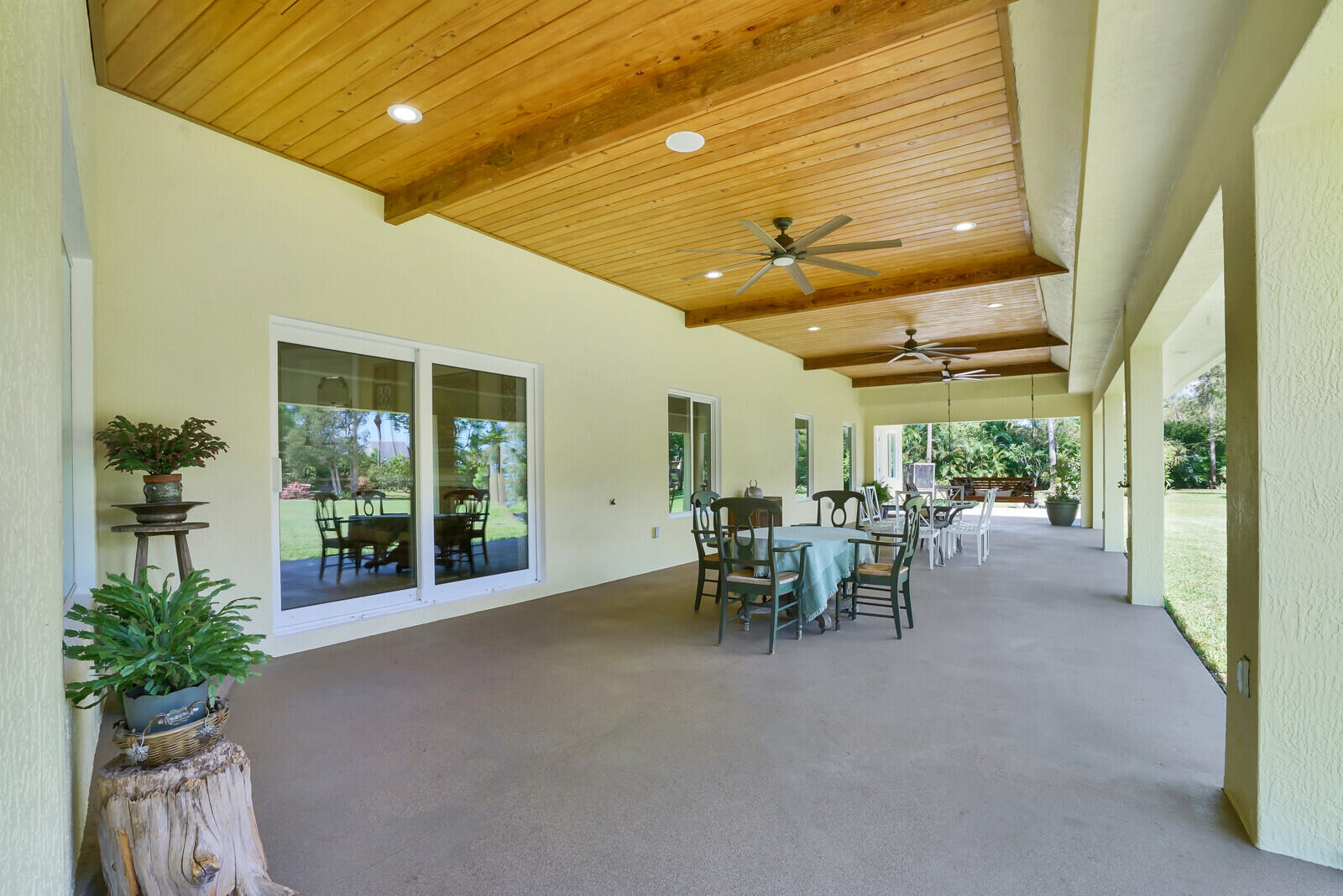 6624 Dillman Road Greenacres, FL 33413 - Photo 39 of 61 a view of a patio with table and chairs potted plants with wooden fence