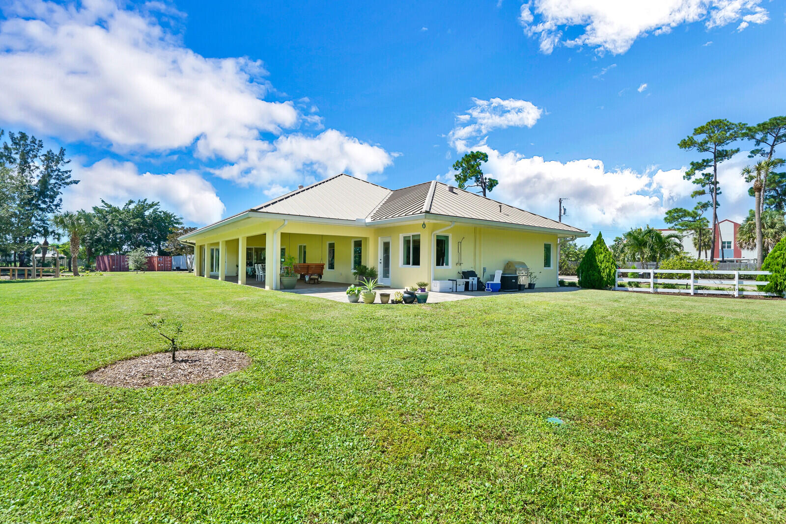 6624 Dillman Road Greenacres, FL 33413 - Photo 47 of 61 a front view of a house with garden