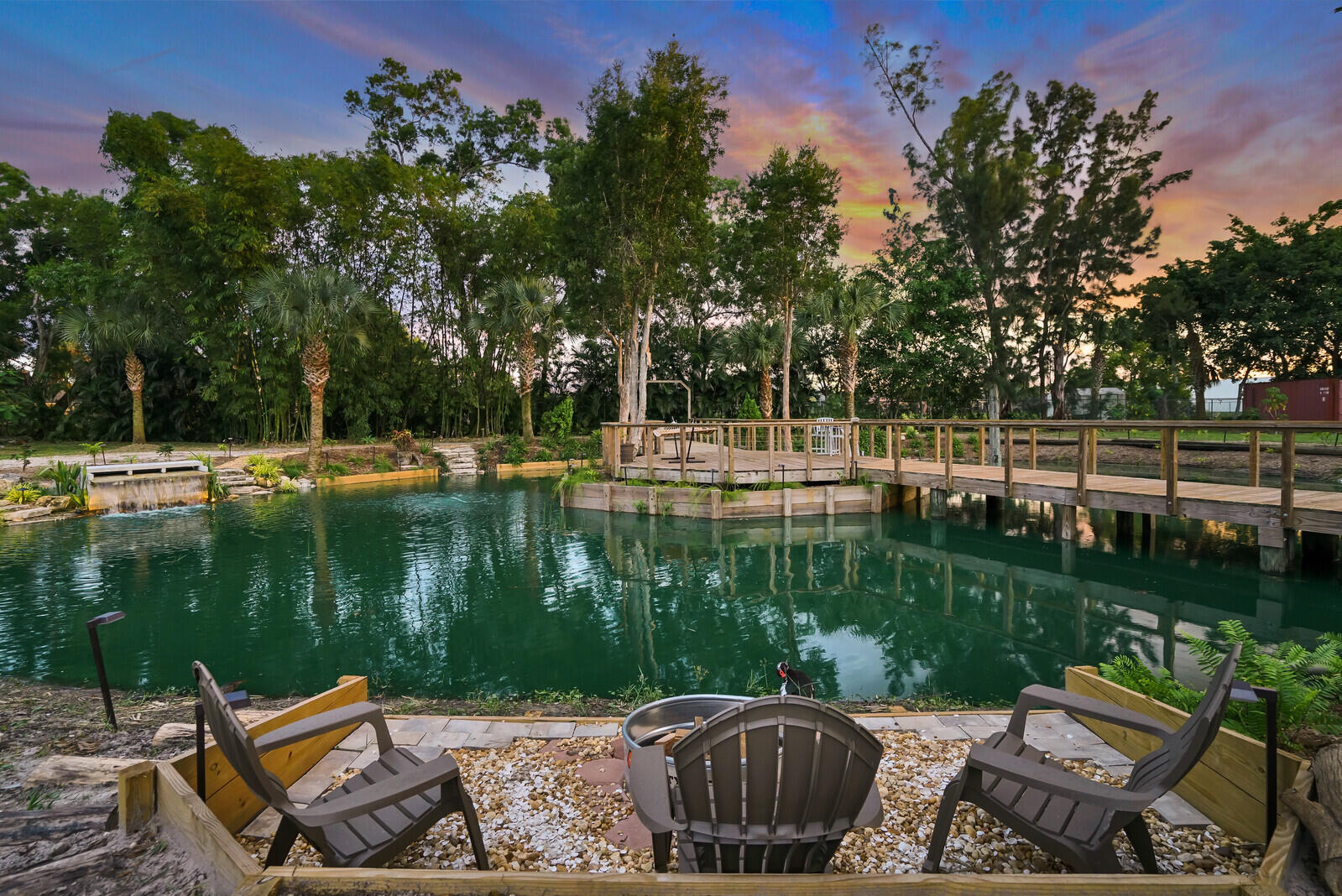 6624 Dillman Road Greenacres, FL 33413 - Photo 5 of 61 a view of a lake with a table and a chairs