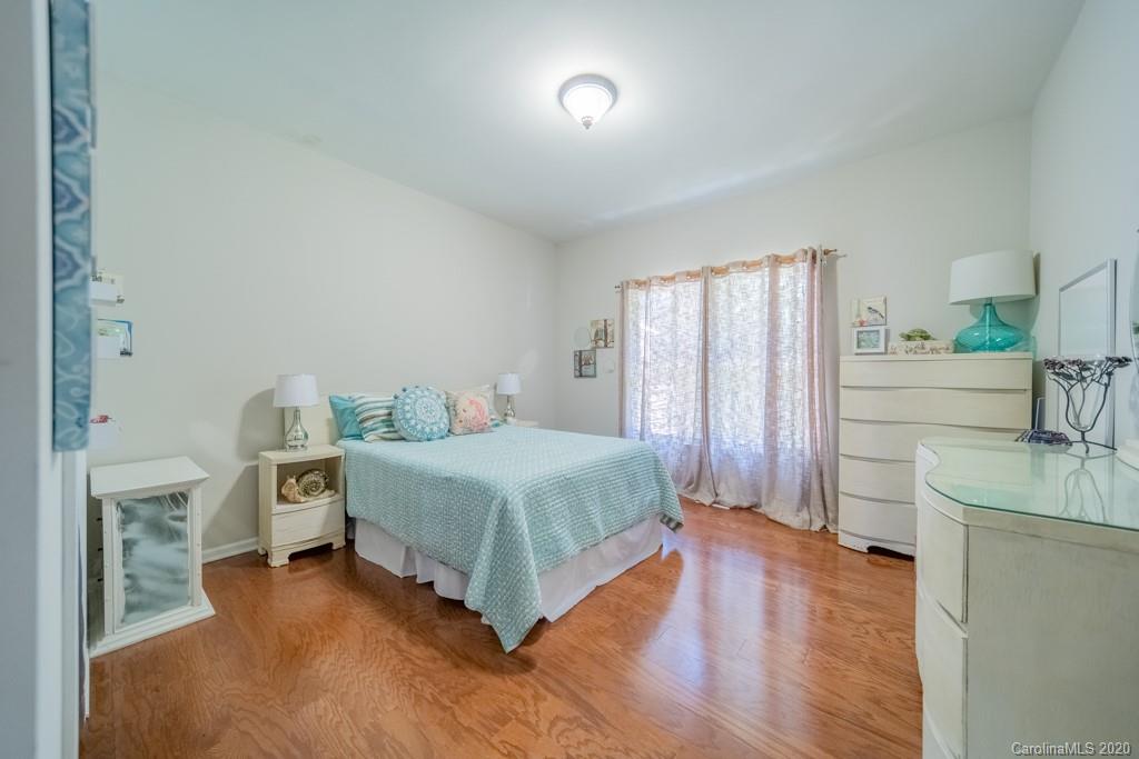 3440 Dobys Bridge Road Fort Mill, SC 29715 - Photo 18 of 25 a spacious bedroom with a bed and a wooden floor