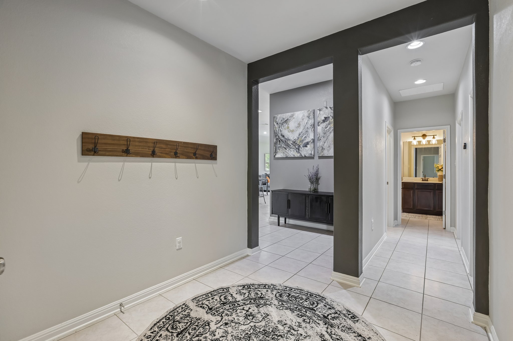 6801 Banff Cove Austin, TX 78754 - Photo 23 of 37 A welcoming entryway with coat hooks, tiled flooring, and a glimpse into adjacent living spaces.