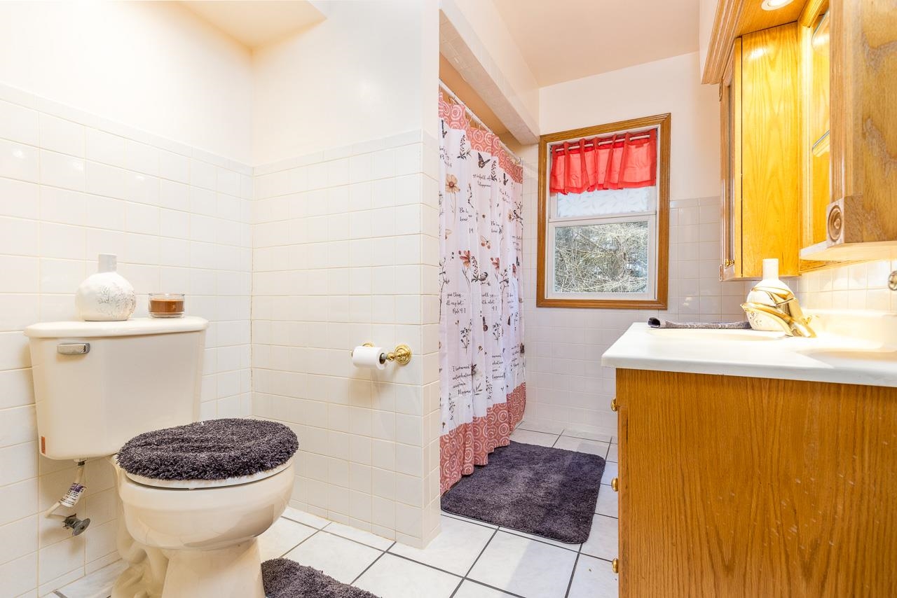 1554 Rural Street Rockford, IL 61107 - Photo 11 of 25 a bathroom with a toilet a sink and a window