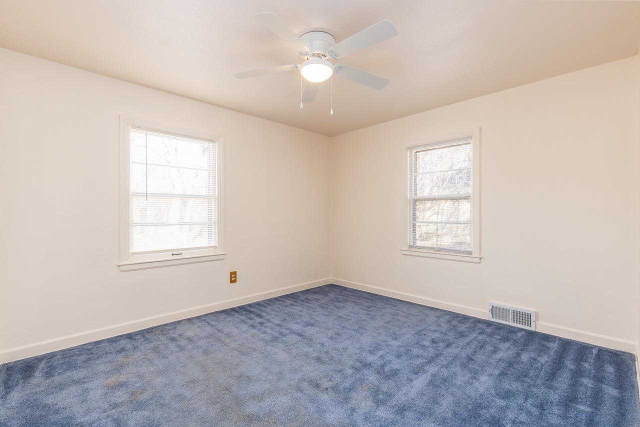 1554 Rural Street Rockford, IL 61107 - Photo 14 of 25 an empty room with chandelier fan and windows