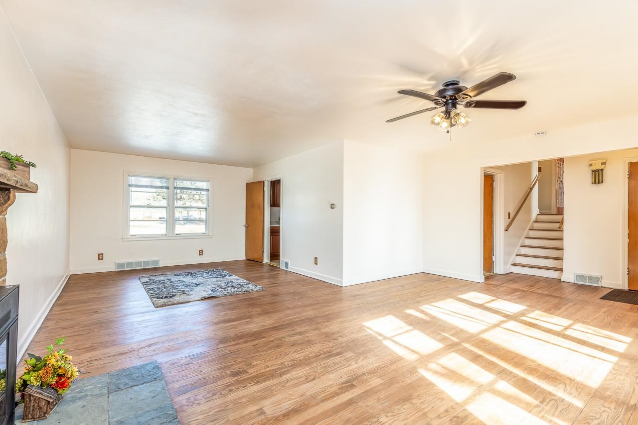 1554 Rural Street Rockford, IL 61107 - Photo 5 of 25 a view of empty room with wooden floor and fan