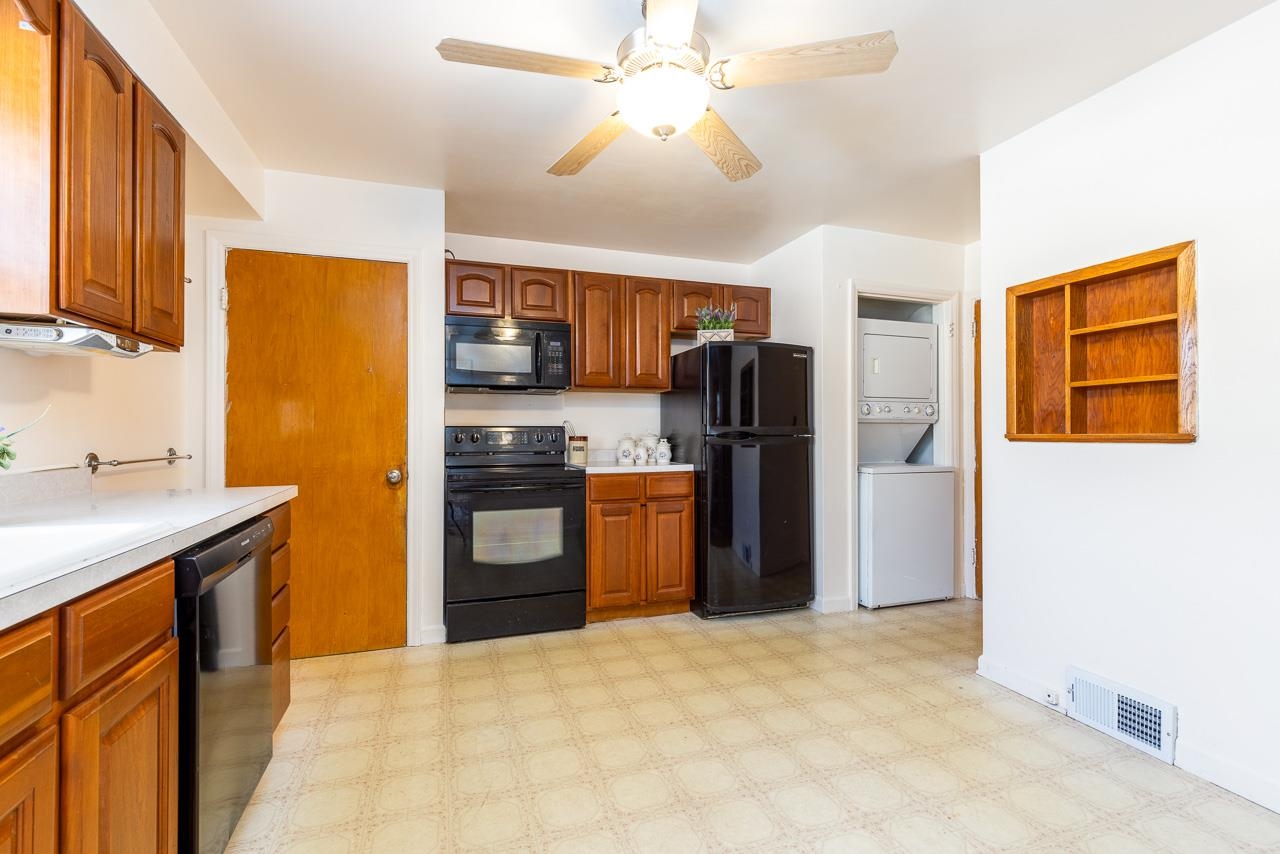 1554 Rural Street Rockford, IL 61107 - Photo 7 of 25 a kitchen with a refrigerator a stove top oven a sink and dishwasher