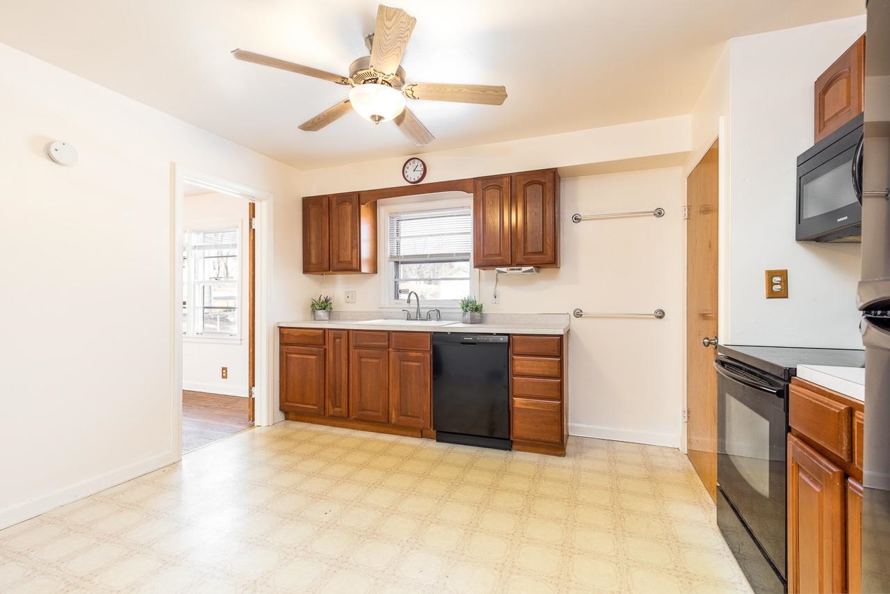 1554 Rural Street Rockford, IL 61107 - Photo 8 of 25 a kitchen with stainless steel appliances a sink dishwasher stove refrigerator and microwave