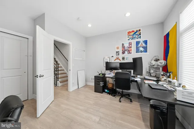 a view of a workspace with furniture and a workspace