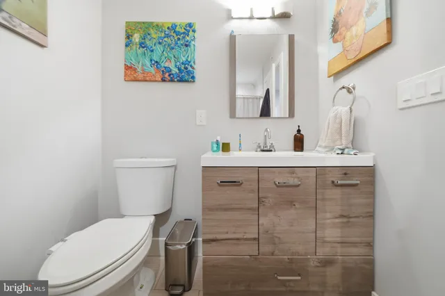 a bathroom with a toilet sink and mirror