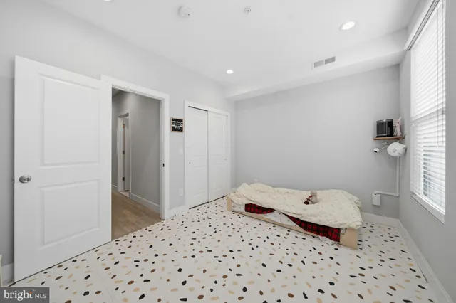 a bedroom with a bed and a window