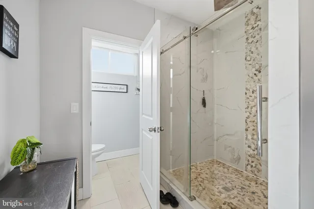 a bathroom with a granite countertop shower
