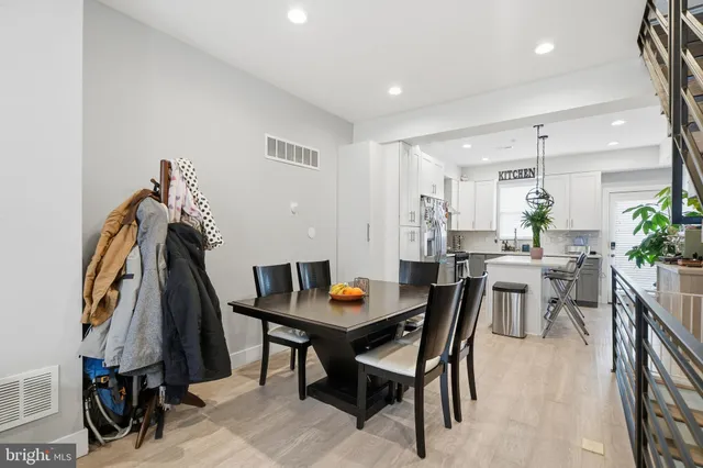 a view of a dining room with furniture and a potted plant