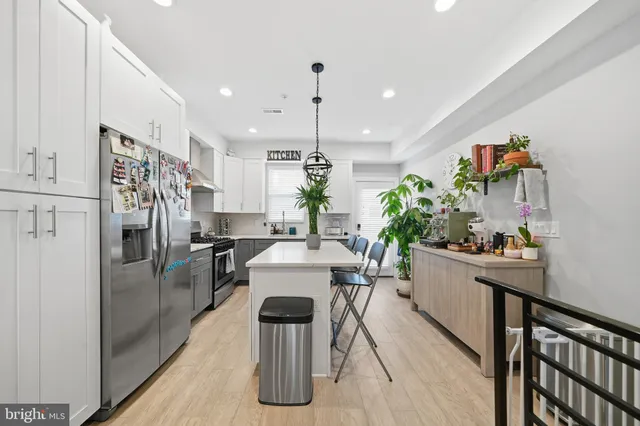 a kitchen with stainless steel appliances granite countertop sink refrigerator and microwave