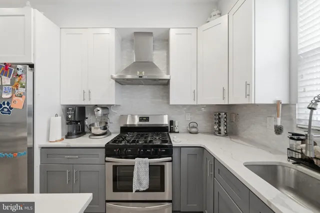 a kitchen with stainless steel appliances a sink stove and cabinets