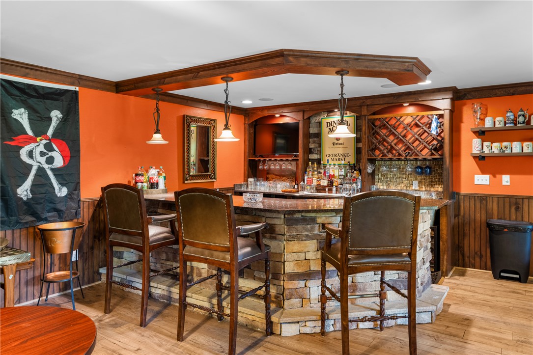 106 Red Maple Way Clemson, SC 29631 - Photo 32 of 49 A stone-wrapped wet bar setup with wood paneling creates an inviting space for entertaining.