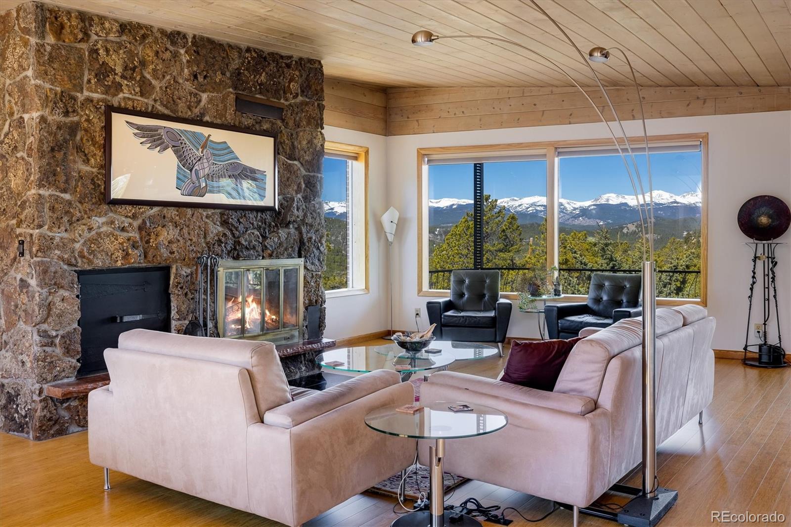 a living room with fireplace furniture and a large window