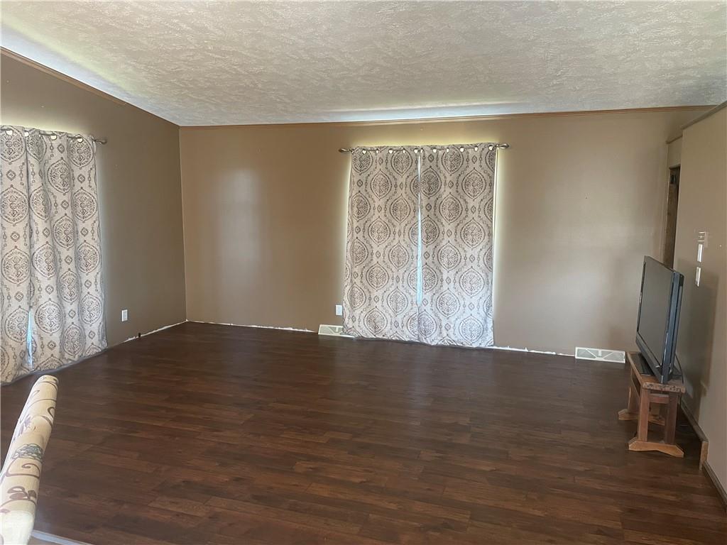57 Pine Road Claysville, PA 15323 - Photo 2 of 16 a view of an empty room with wooden floor and a window