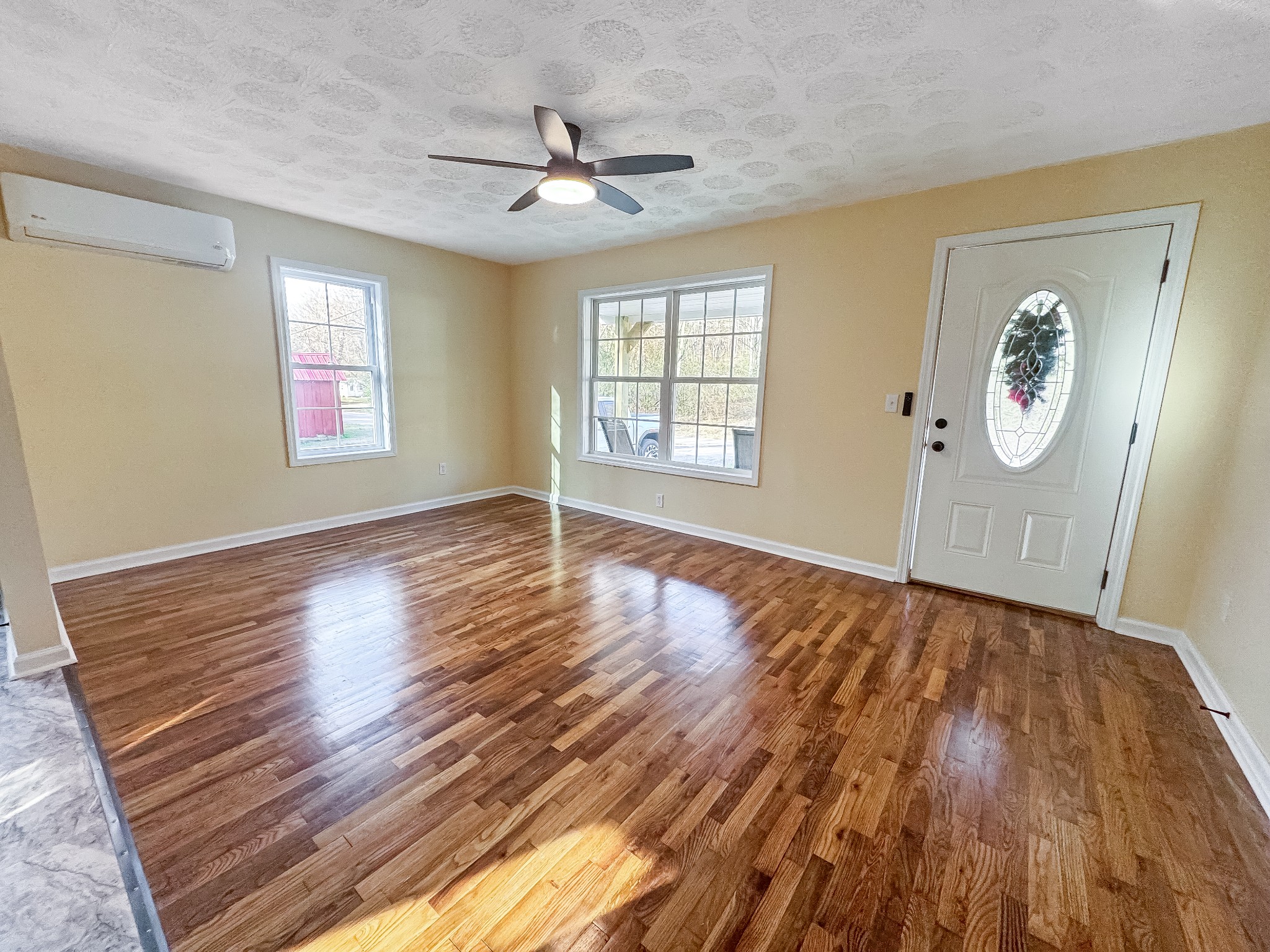 608 Big Rock Road Big Rock, TN 37023 - Photo 2 of 15 a view of an empty room with wooden floor and a window