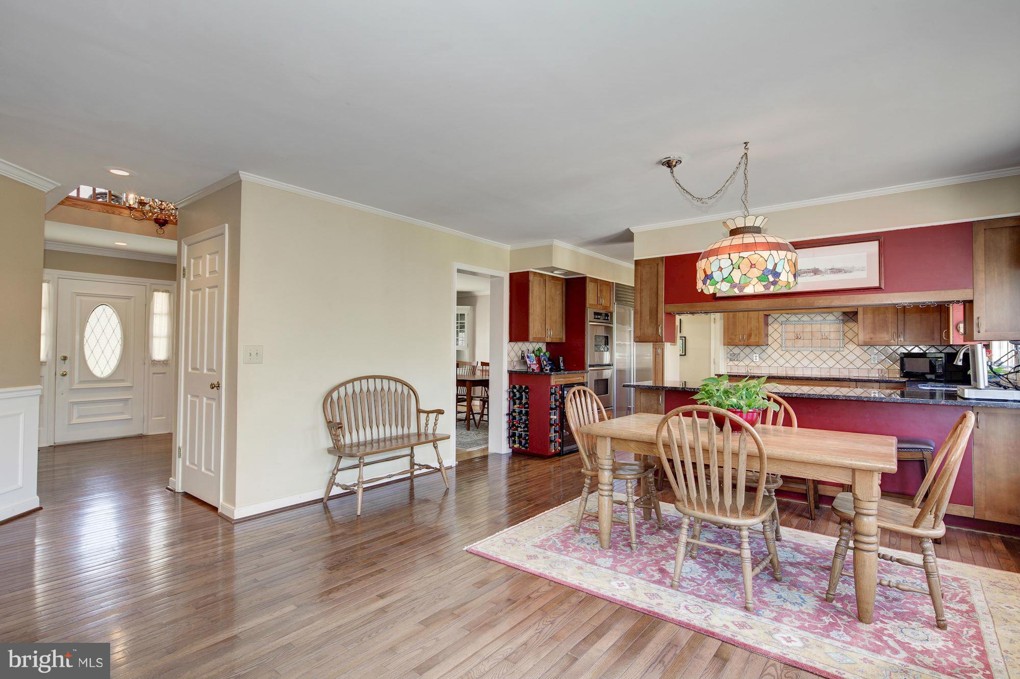 14206 Robcaste Road Phoenix, MD 21131 - Photo 8 of 30 a dining room with furniture a chandelier and wooden floor