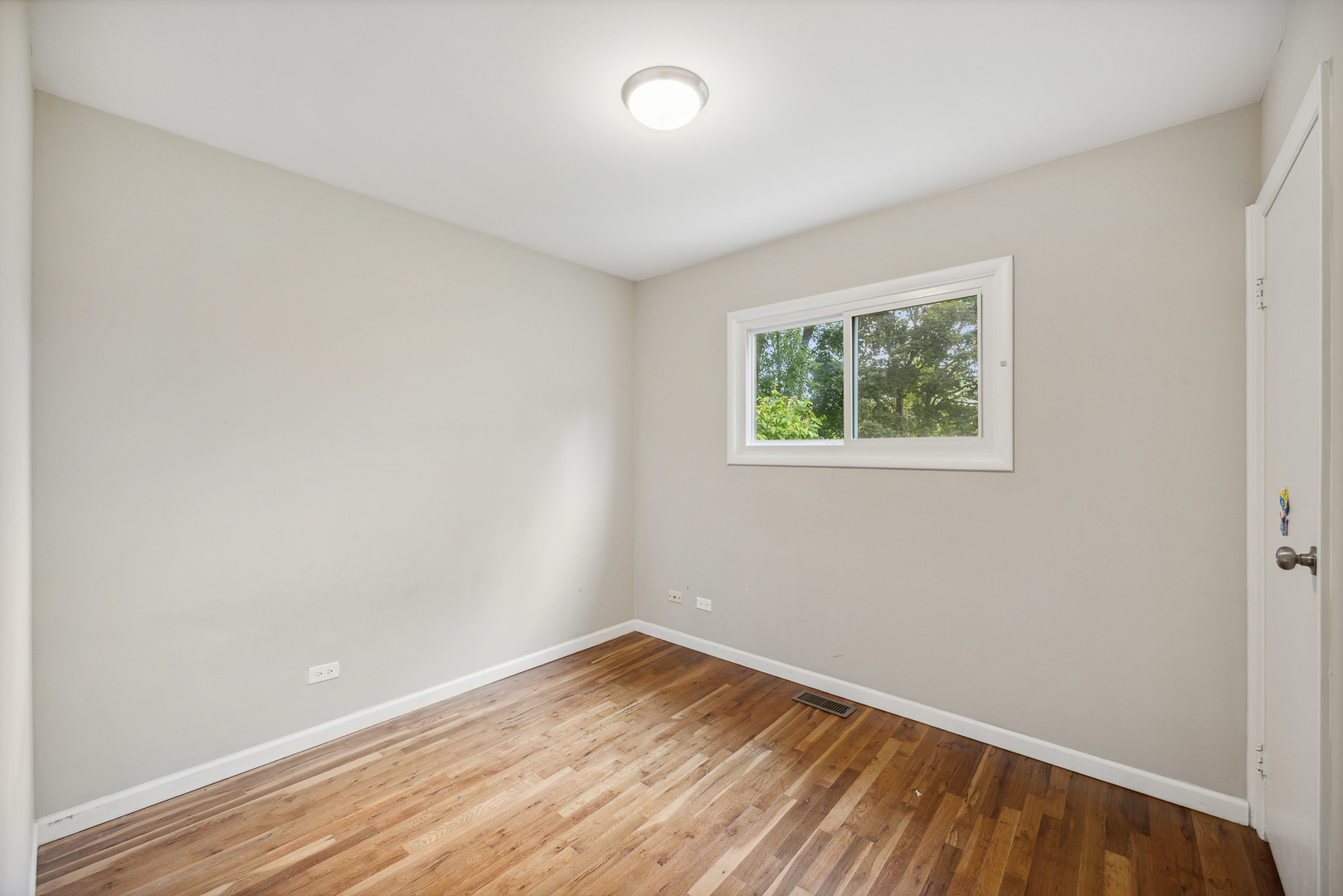 660 Alcoa Lane Hoffman Estates, IL 60169 - Photo 23 of 33 an empty room with wooden floor and windows