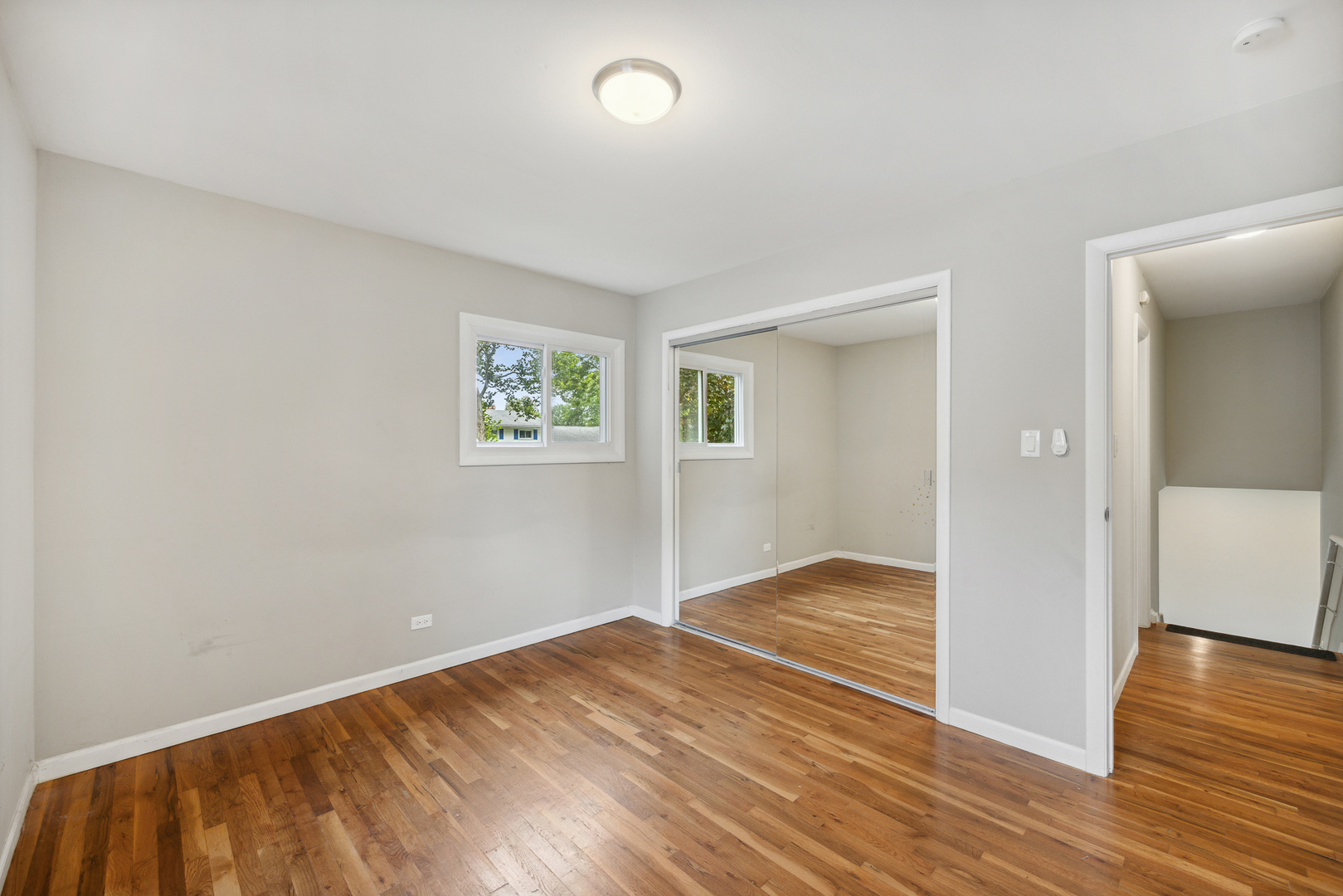 660 Alcoa Lane Hoffman Estates, IL 60169 - Photo 28 of 33 an empty room with wooden floor and windows