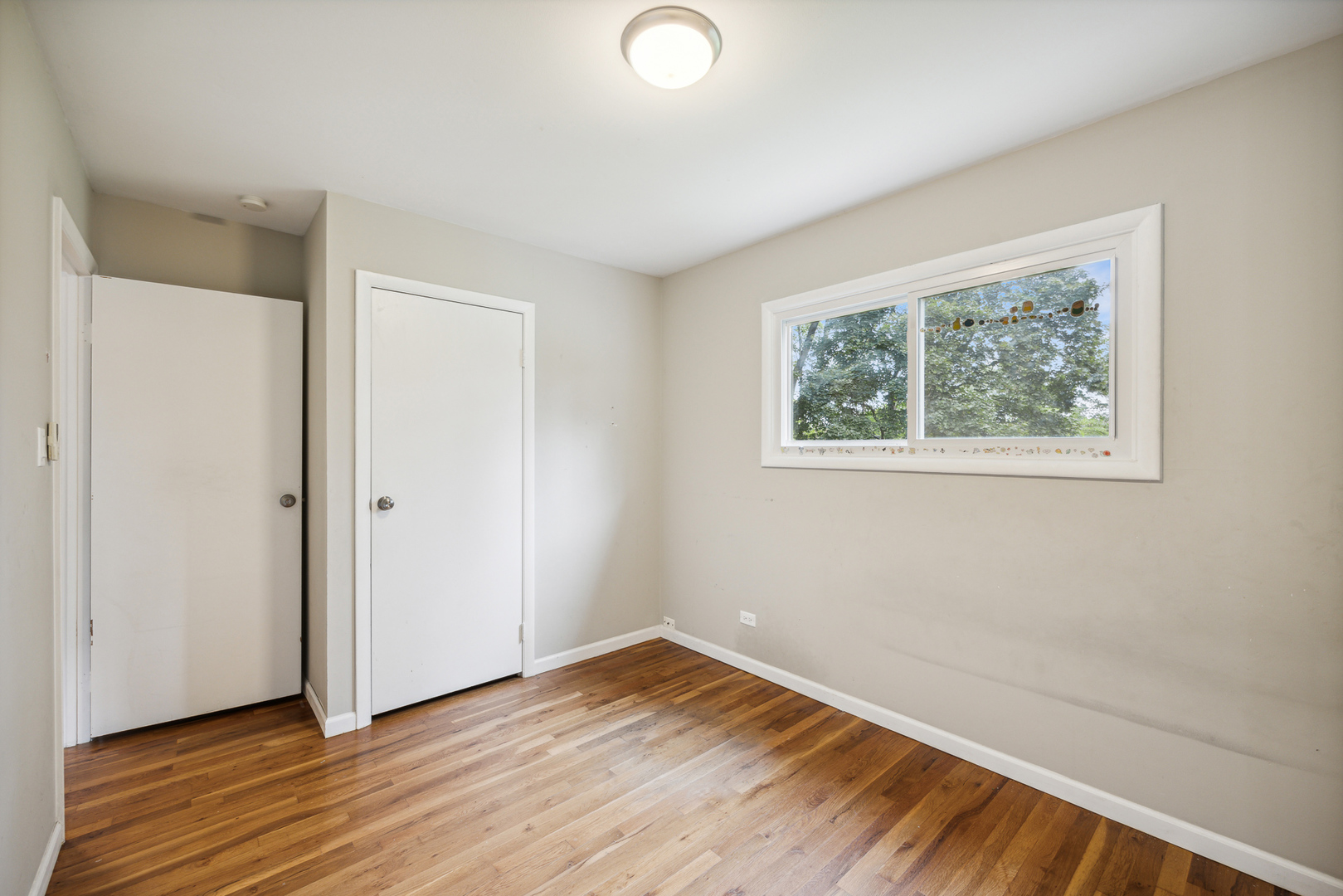 660 Alcoa Lane Hoffman Estates, IL 60169 - Photo 29 of 33 an empty room with wooden floor and windows