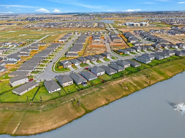 an aerial view of residential houses with outdoor space