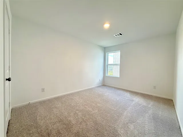 a large kitchen with a stove a sink and a refrigerator