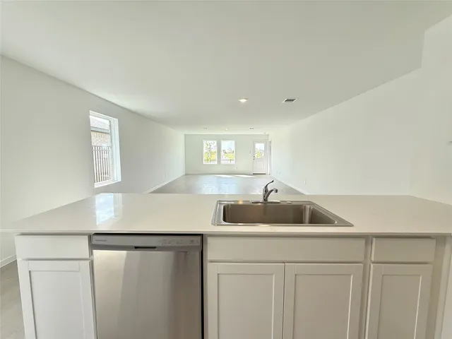 a view of a hallway to a bedroom and window