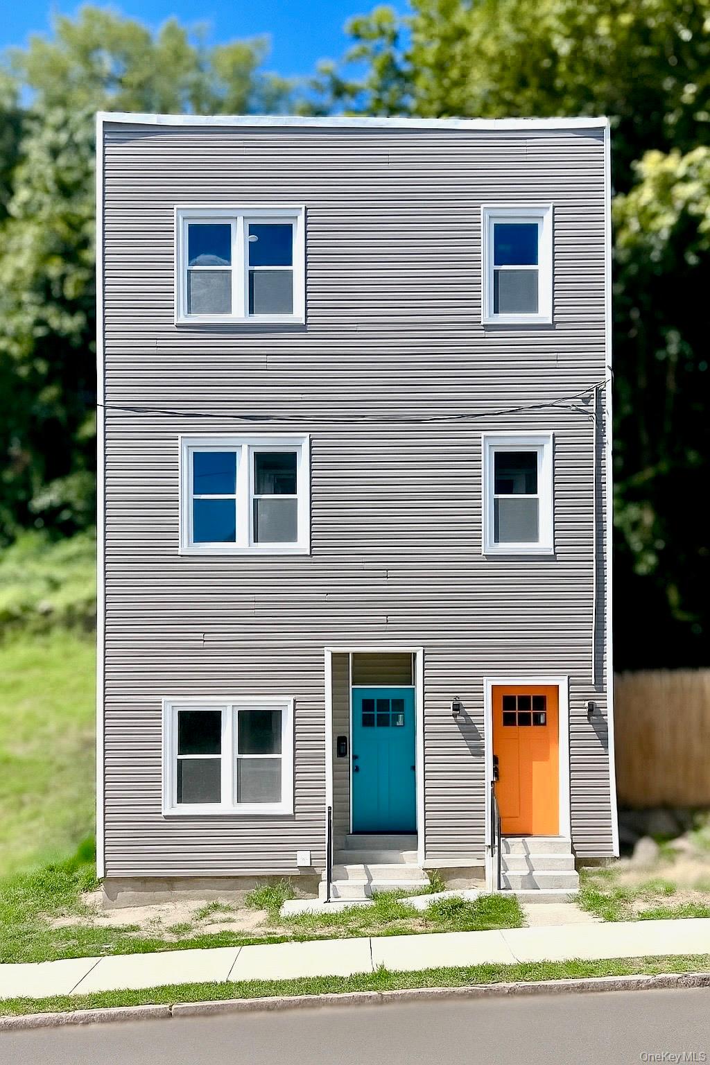 a view of a brick house many windows and a table